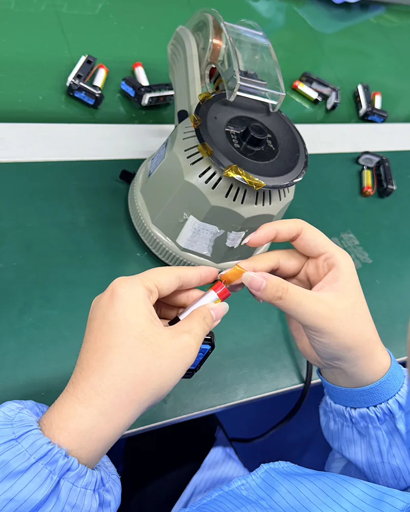 Custom Vape Manufacturing (OEM/ODM): A Practical Guide for Global Brands 2 Heat-shrink insulation applied to a battery cell on the assembly line
